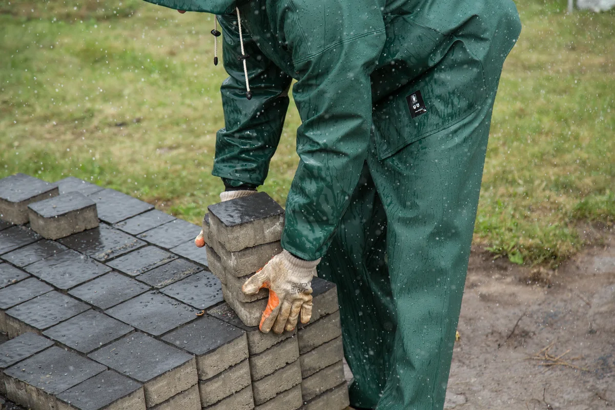 Pavers being lifted from a stack during a relay