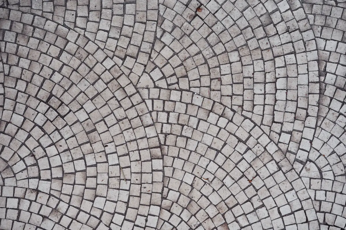 Small setts laid in a fan pattern across a large paved area