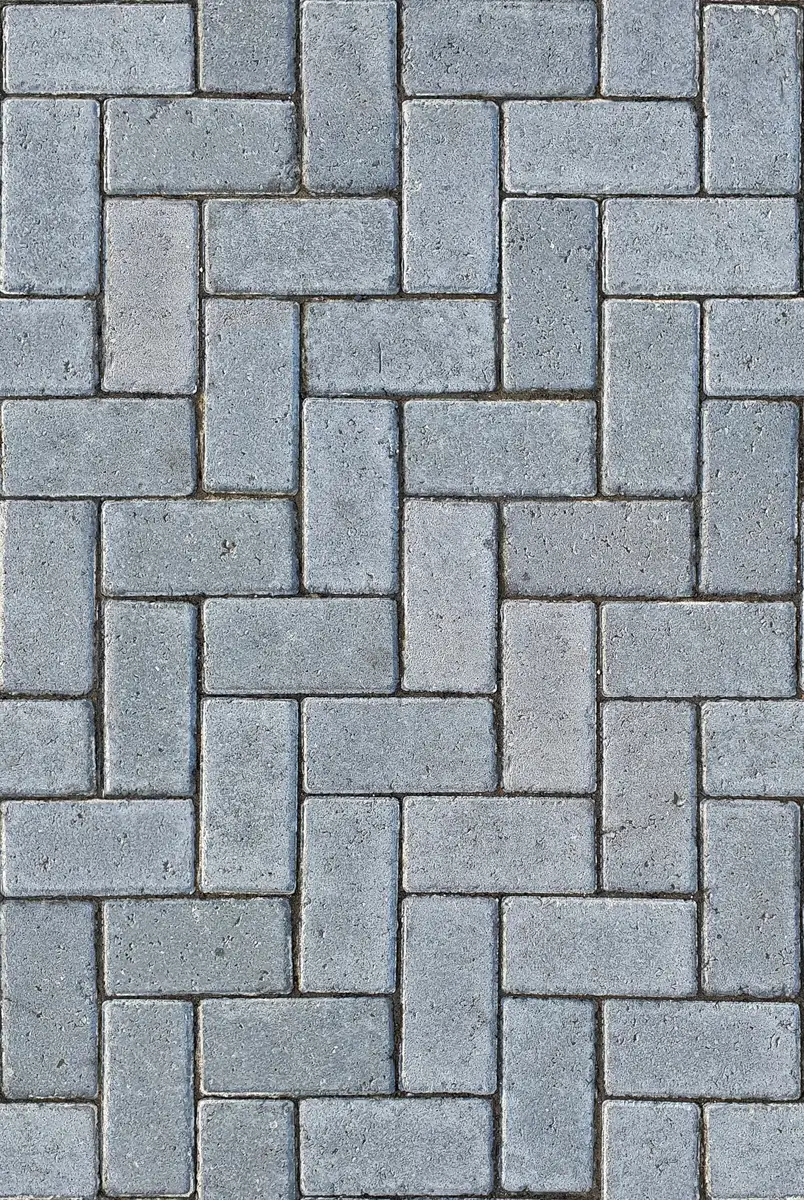 Clean grey herringbone paving with fully filled joints