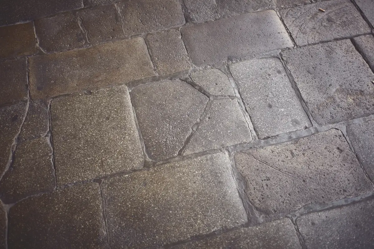 Close view of paver joints on a cobblestone-texture walkway