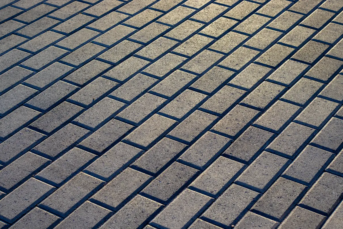 A paver surface in perspective with joints running dark and low