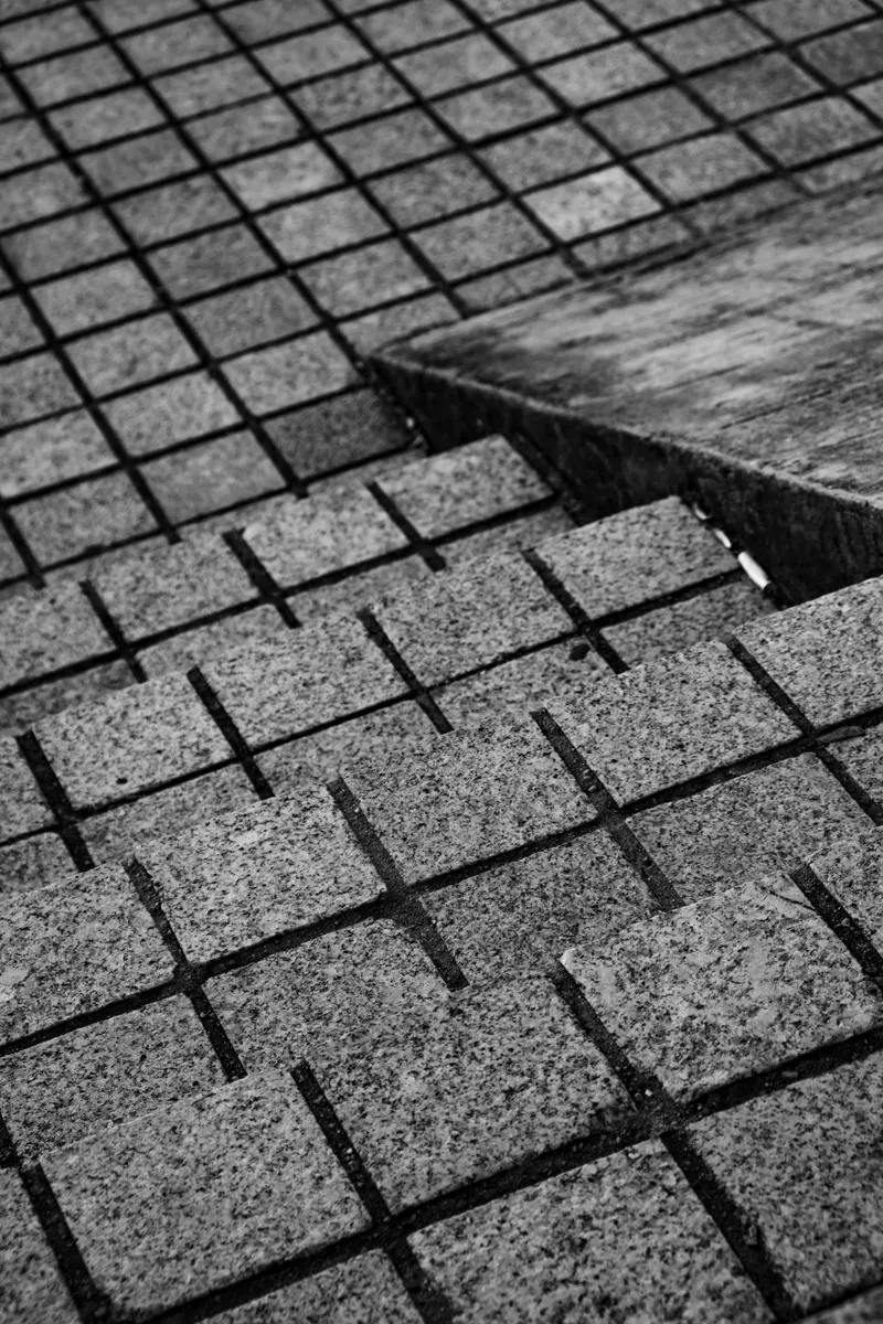 A level change where one field of granite setts steps up to another