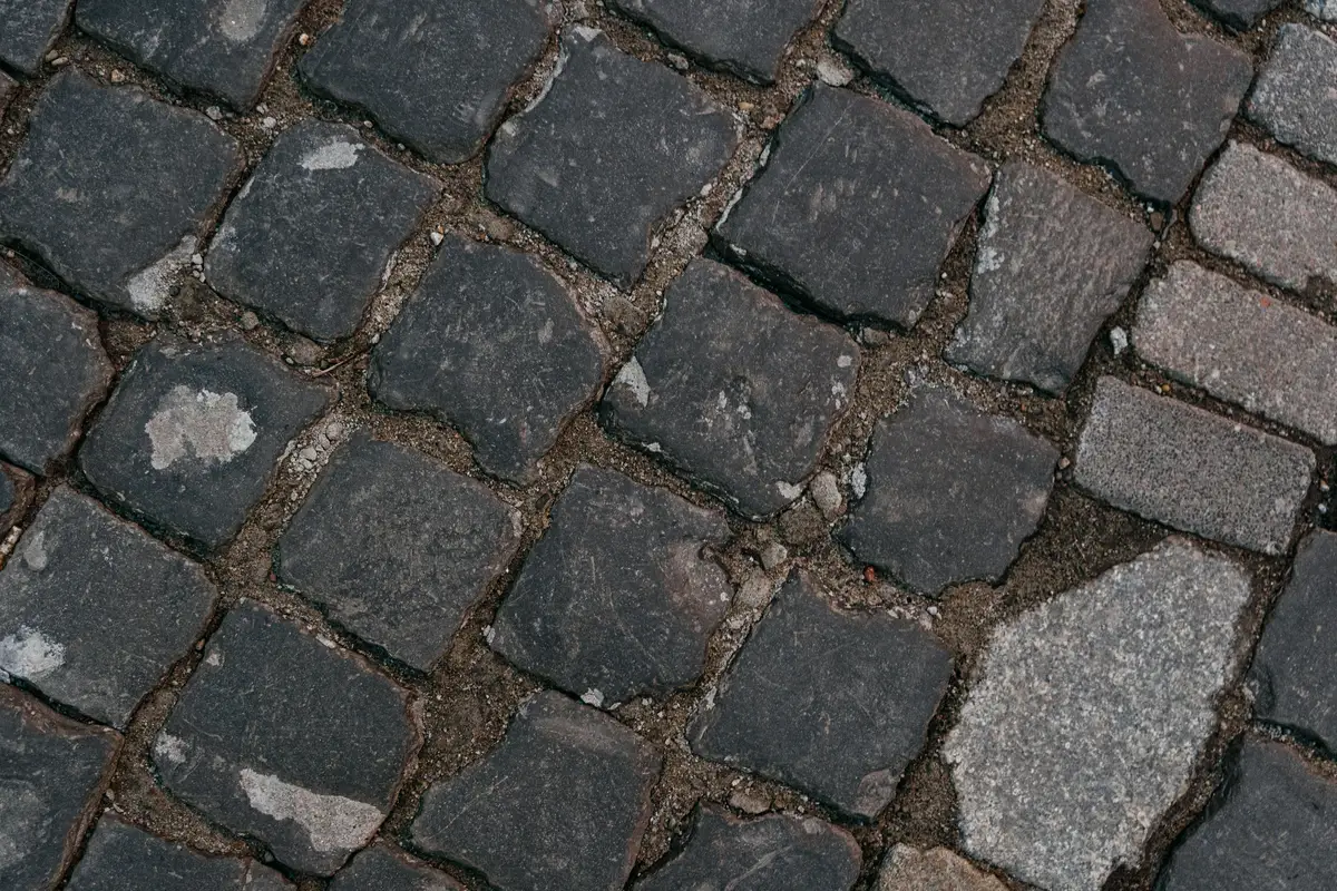 Worn setts with sand washed out of the joints before cleaning